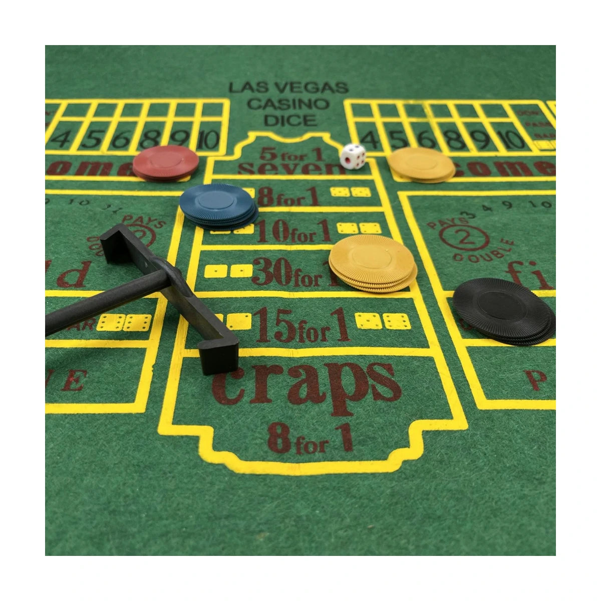 Craps felt mat close-up with chips and dealer rake, casino games set details