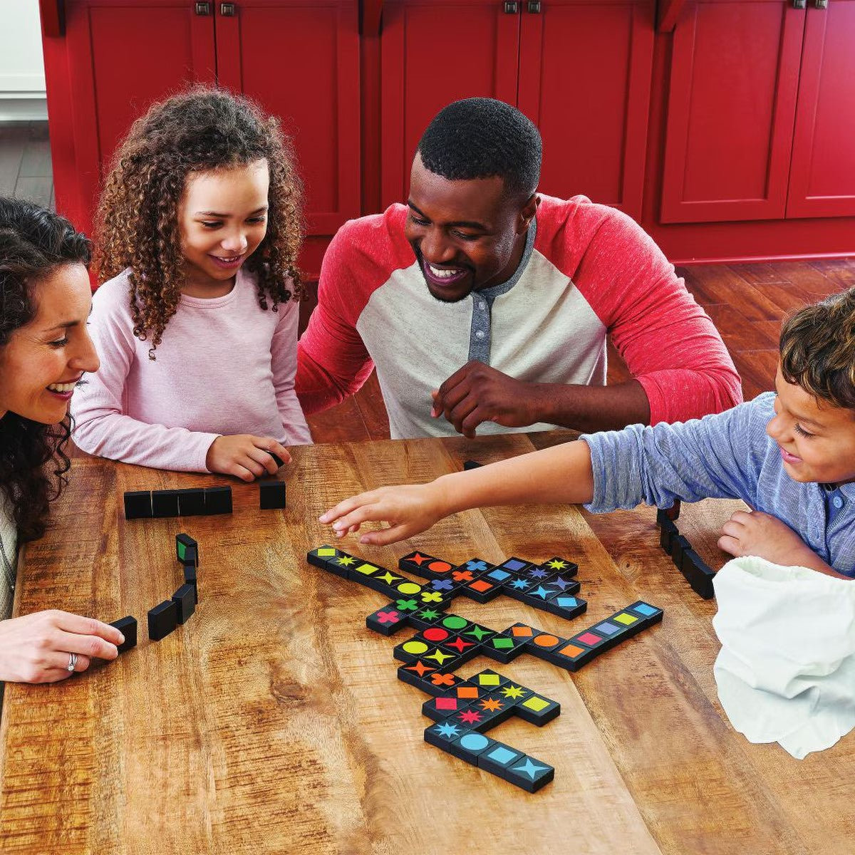Family playing Qwirkle together at a table