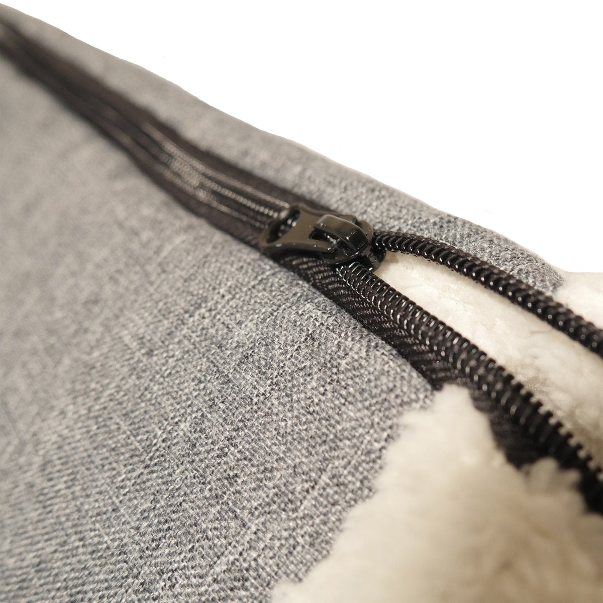 Close-up of the zip on the Rosewood Snuggle Plush 2-in-1 Cat Comfort Den showing the grey fabric and cream plush material