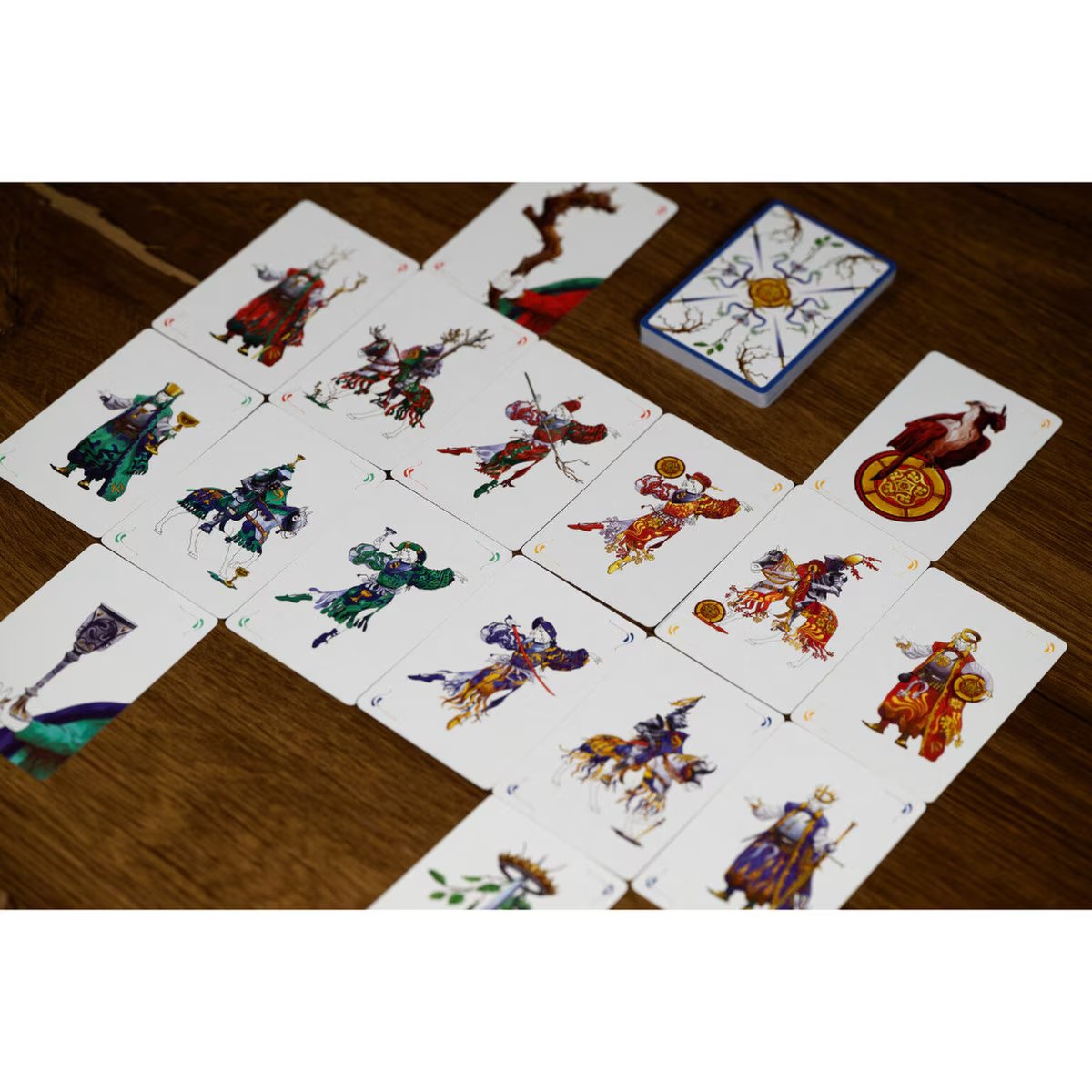 Scopa card capture gameplay layout showing illustrated Italian-style cards and deck on a wooden table