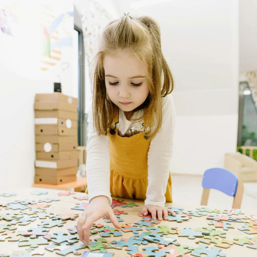 6 year old girl solving a puzzle- Educational Puzzles - Afrishon World