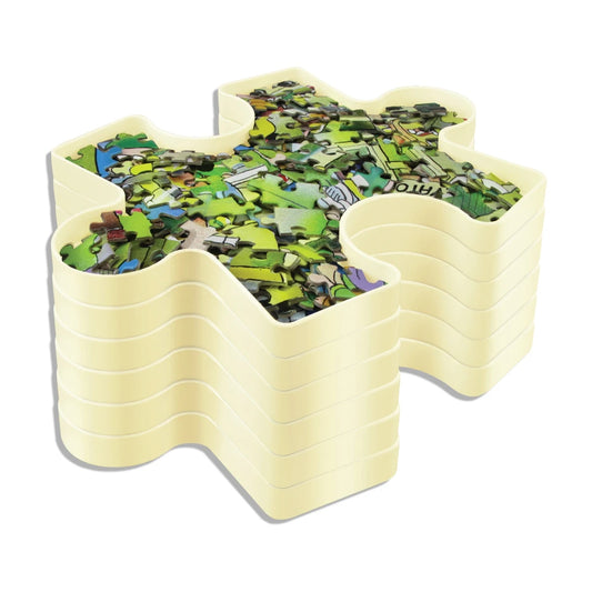 Stackable puzzle sorting tray filled with jigsaw pieces on white background (puzzle piece organizer)