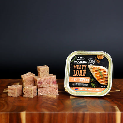 Absolute Holistic Meaty Loaf Chicken tray and cubed loaf displayed on a wooden table