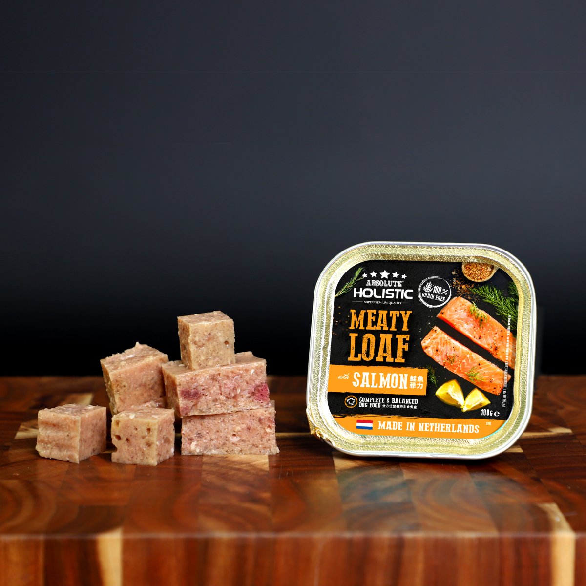 Absolute Holistic Meaty Loaf Salmon tray and cubed loaf displayed on a wooden table
