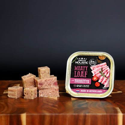 Absolute Holistic Meaty Loaf Turkey tray and cubed loaf displayed on a wooden table
