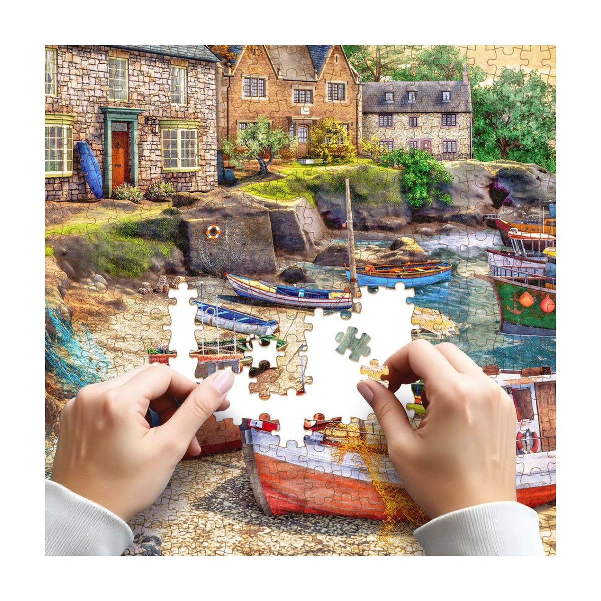 Hands placing pieces on the RGS English Harbour Life 1500 piece puzzle showing detail and fit