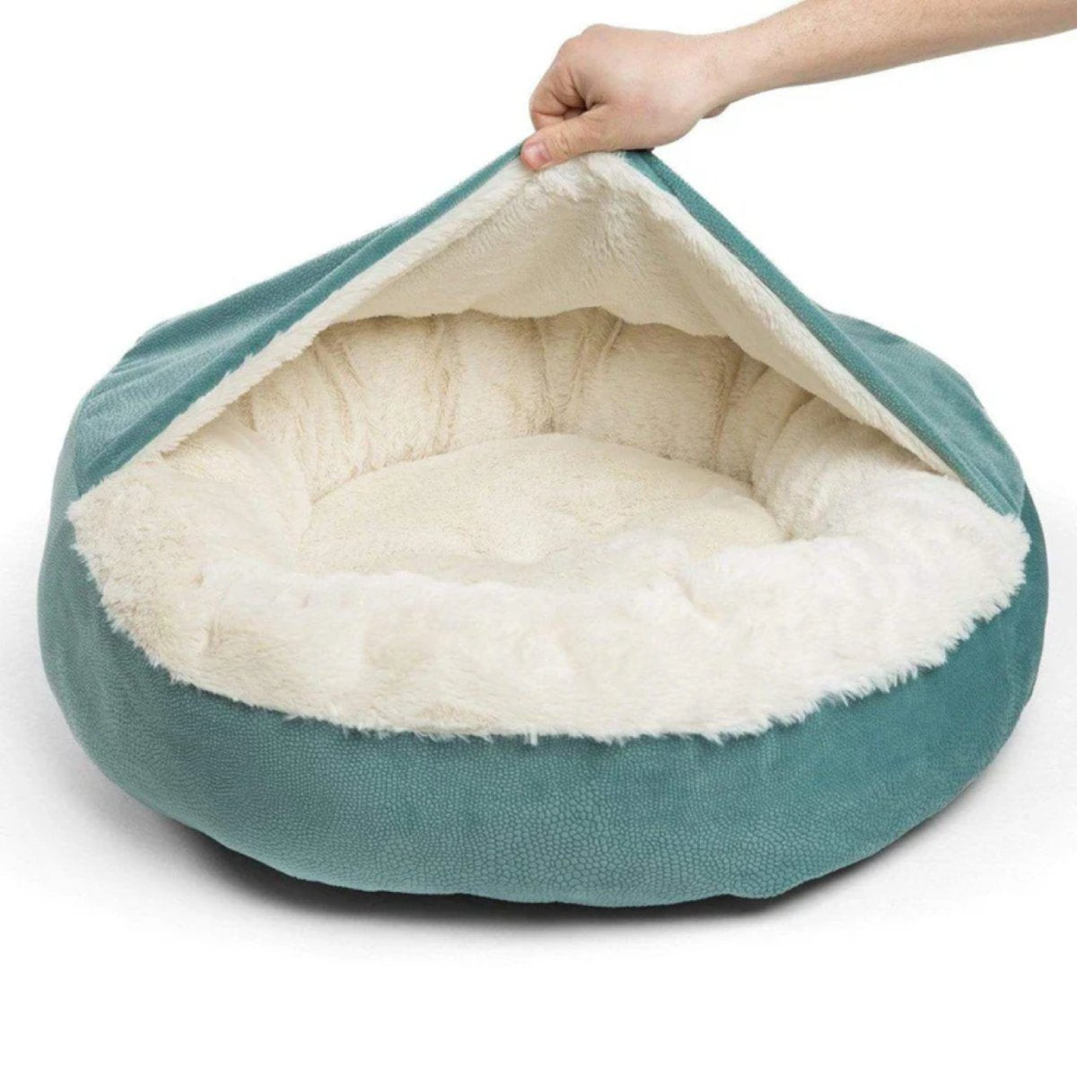 Pool Cozy Cuddler Ilan pet bed with its attached blanket lifted, revealing the plush cream faux fur sleeping area and cushioned surrounding walls.