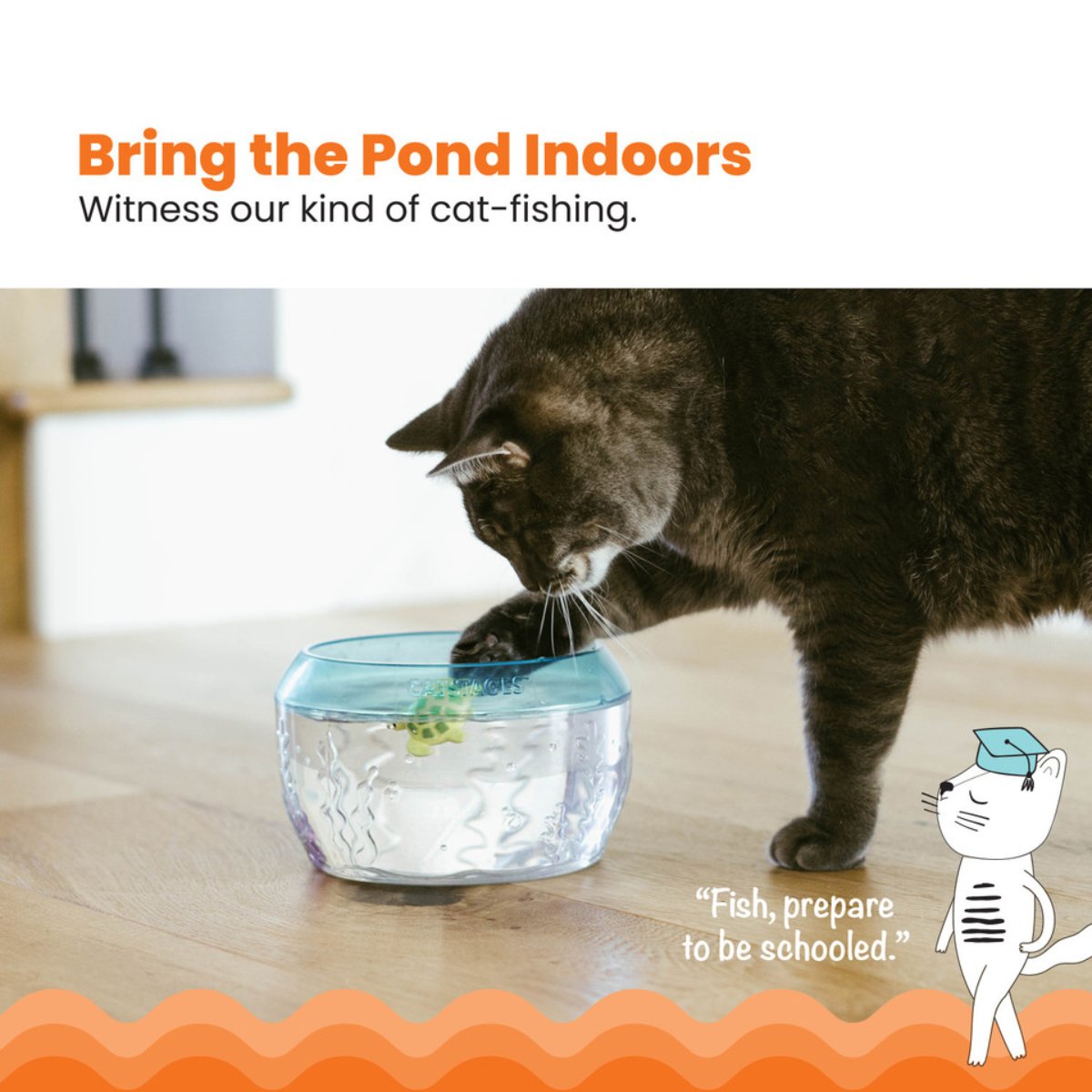 Cat pawing at the Catstages MEOW-SMERIZING Fish Bowl Cat Toy with floating water toys inside
