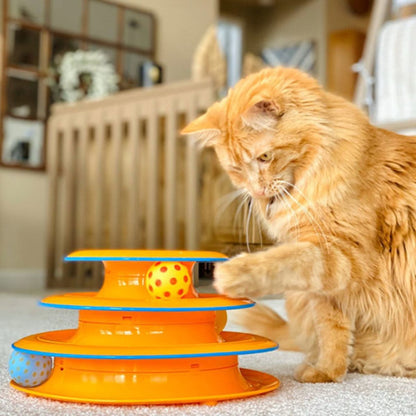 Orange cat batting the spinning ball on the Catstages Tower of Tracks Cat Toy