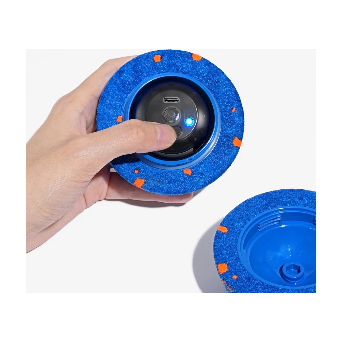 Close up of Cheerble Wicked Ball AIR controls and USB C charging port inside blue shell