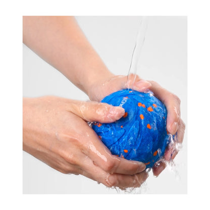 Rinsing Cheerble Wicked Ball AIR outer shell under running water for easy cleaning