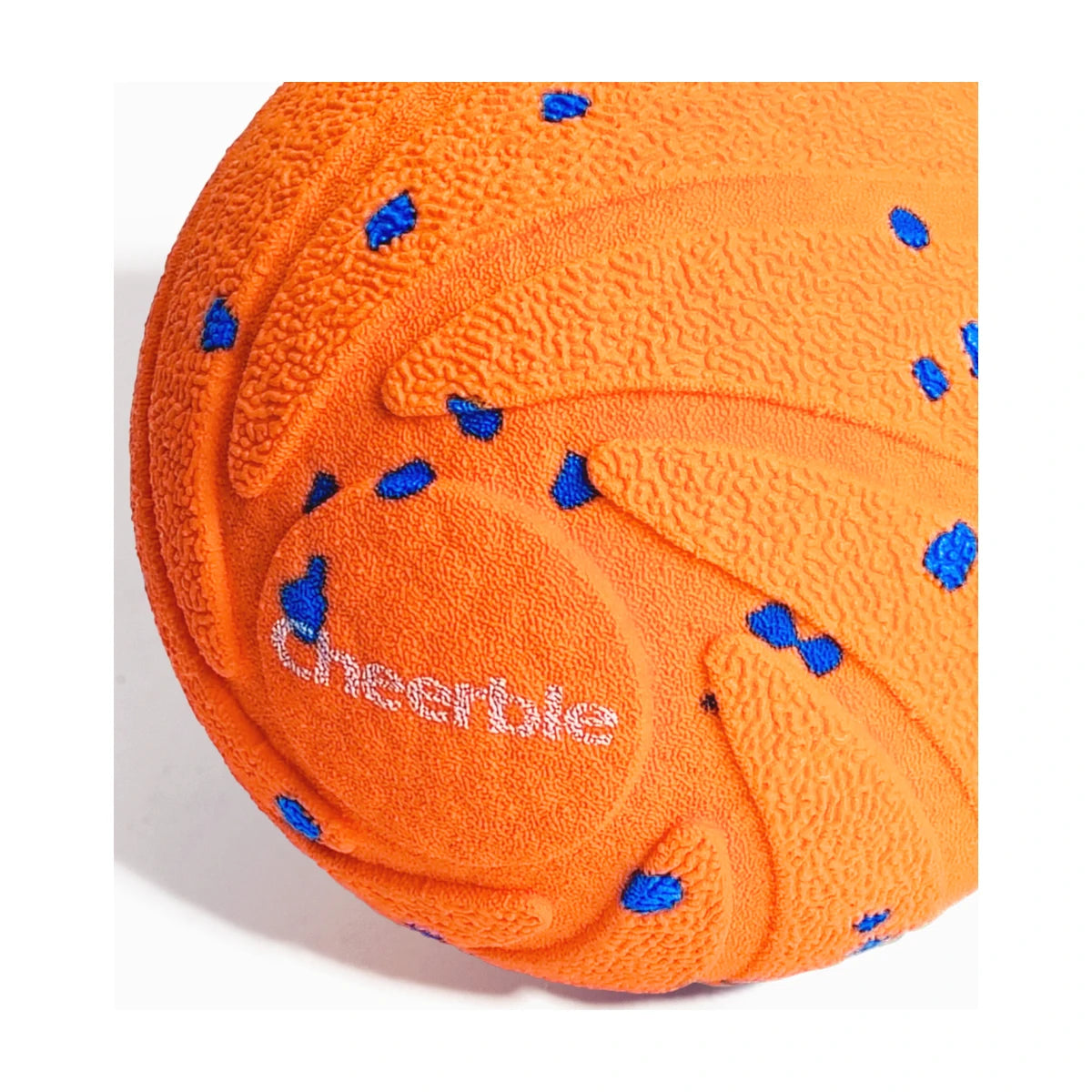 Close up of orange Cheerble Wicked Ball AIR textured outer shell detail