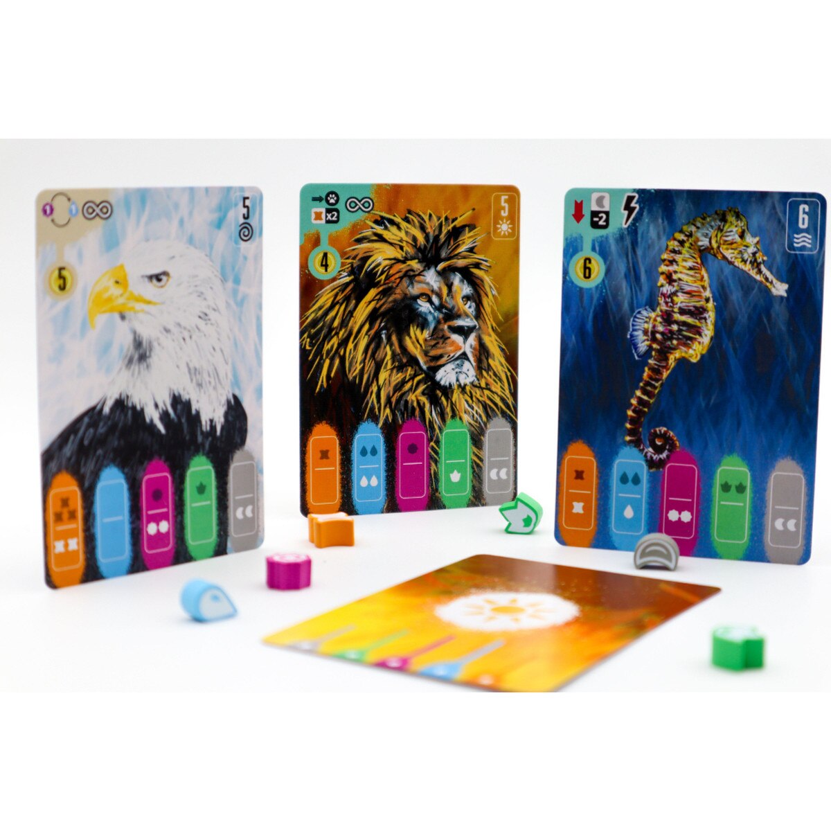 Coexist strategy board game animal cards and tokens showing eagle lion and seahorse cards