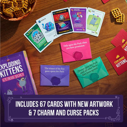 Exploding Kittens Curse You cards and colourful sealed secret packs arranged on a table