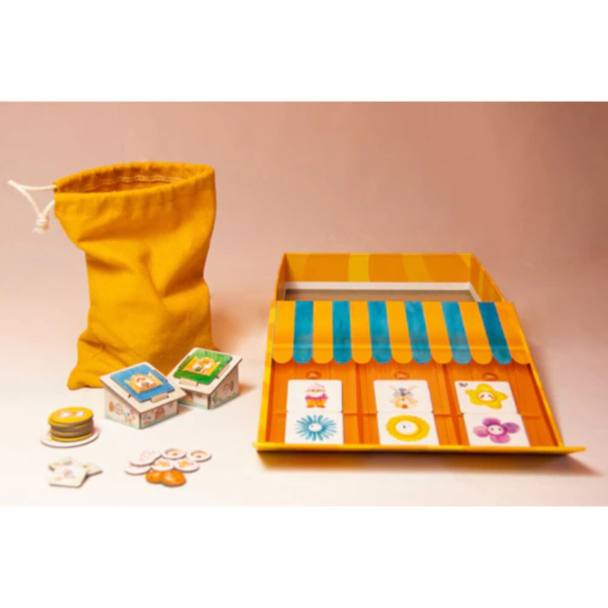 Happy Garden board game components with garden centre board, tiles, bag, and tokens arranged for play