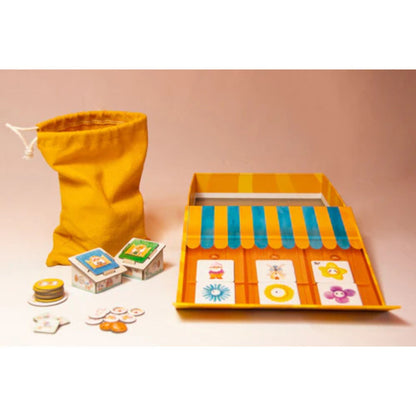 Happy Garden board game components with garden centre board, tiles, bag, and tokens arranged for play
