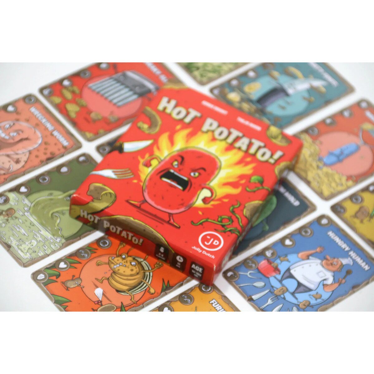 Hot Potato! card game box resting on a spread of colourful illustrated Potato cards