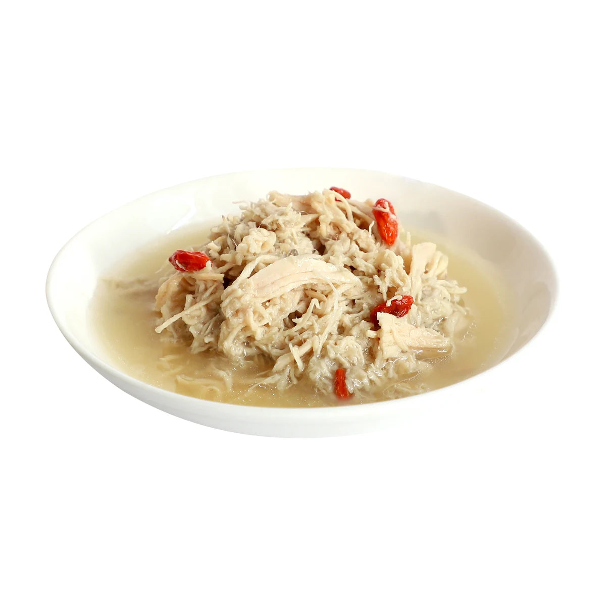 Chicken flakes and red goji berries served in broth on a white plate