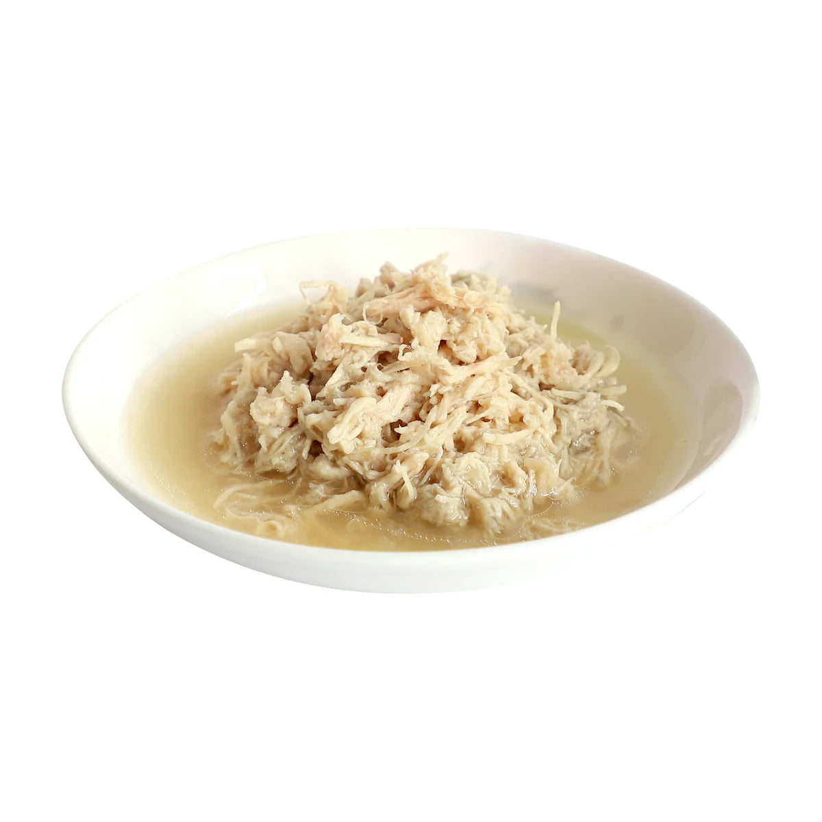 Tender chicken flakes in broth served on a white plate