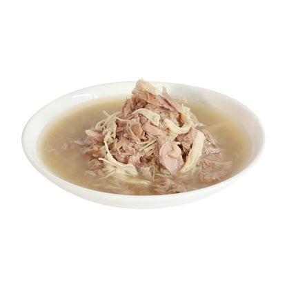 Tuna and chicken meat flakes served in broth on a white plate