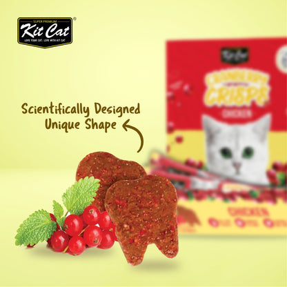 Close-up of crunchy tooth-shaped Kit Cat Cranberry Crisps Chicken cat treats with cranberry illustrations and red product packaging in the background.
