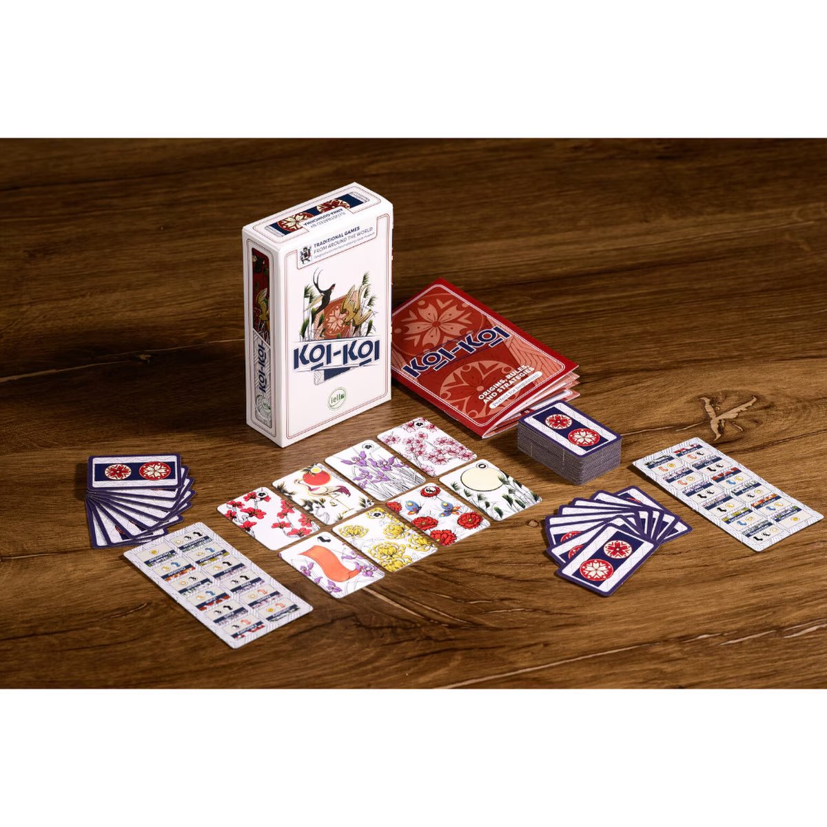 Koi-Koi card game table setup showing Hanafuda cards, rulebook, player aids and box
