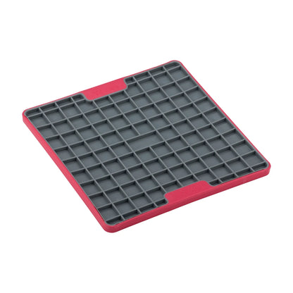 Angled view of red LickiMat Playdate TUFF lick mat with square pattern texture