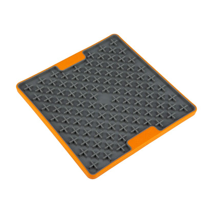 Angled view of the LickiMat TUFF Buddy  Orange lick mat showing the textured cross pattern for slow feeding