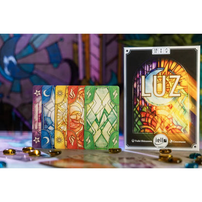 LUZ card game setup showing colourful stained-glass cards, glass beads and box