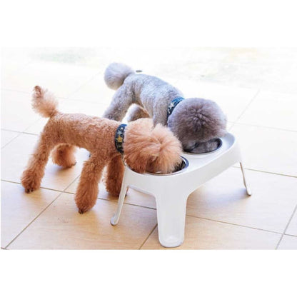 Two dogs eating from a Moderna Skybar elevated dog feeder