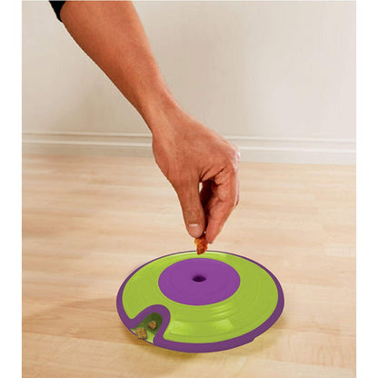 Filling the Nina Ottosson Treat Maze dog puzzle with treats through the top opening
