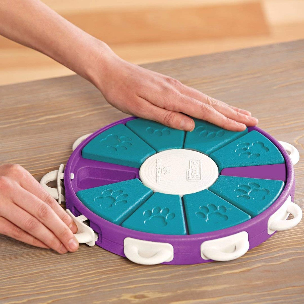 Hands showing how to unlock and lock handles on the Nina Ottosson Dog Twister puzzle