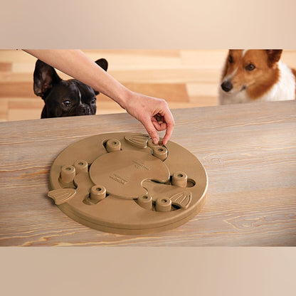 Hand filling Nina Ottosson Dog Worker Composite puzzle with treats for interactive training play