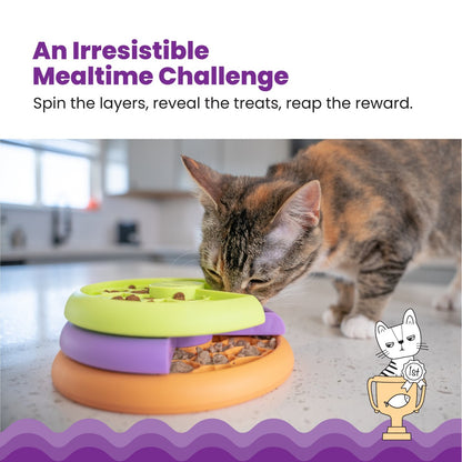 Cat using Nina Ottosson Kitty Lickin Layers puzzle feeder for slower eating and treat hunting
