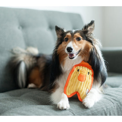 Dog holding Outward Hound Durablez Mini Chicken yellow plush dog toy