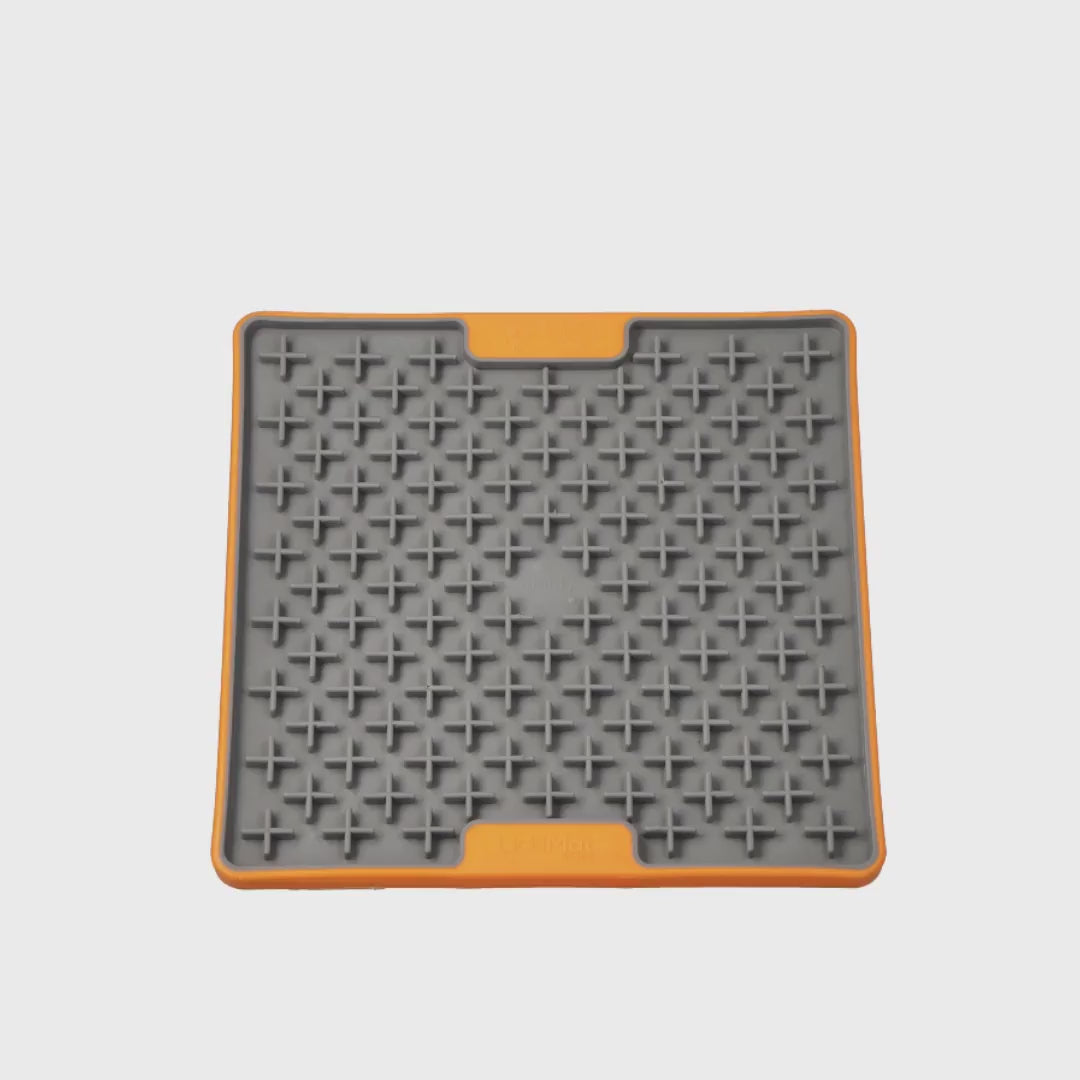 Video showing the LickiMat TUFF Buddy Orange slow feeder lick mat for dogs and cats on a white background