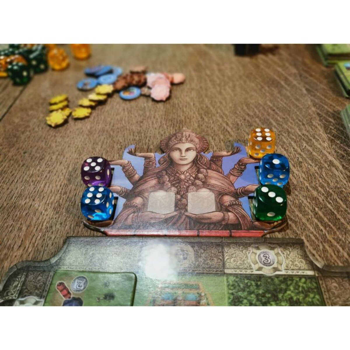 Rajas of the Ganges Kali board holding colourful dice beside the player province board
