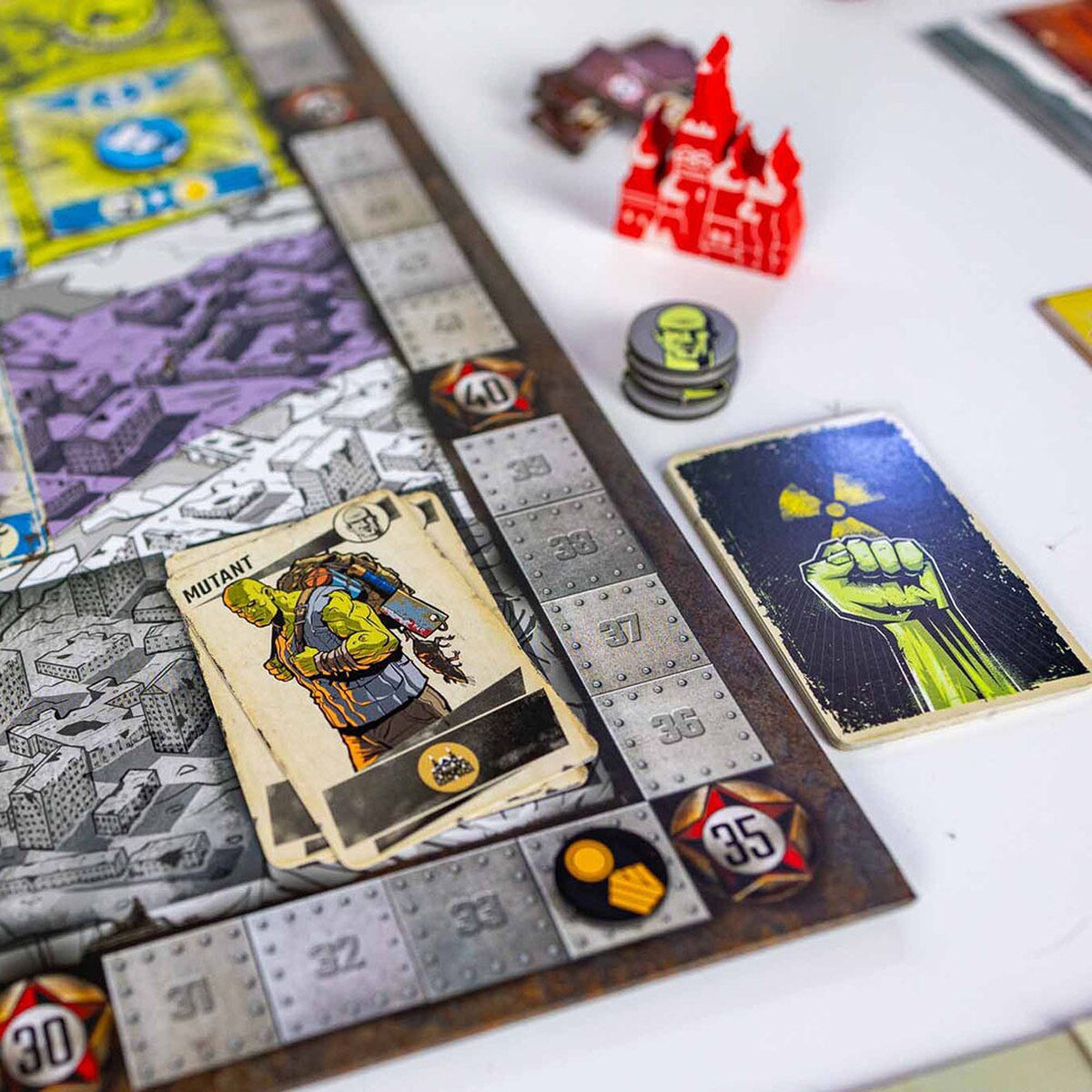 Resurgence board game close-up showing mutant card tokens and scoring track