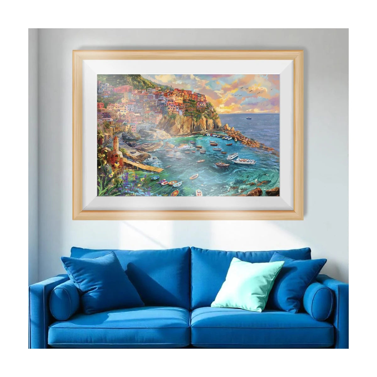 Framed Amalfi Cove jigsaw puzzle artwork displayed as wall art above a sofa in a living room setting