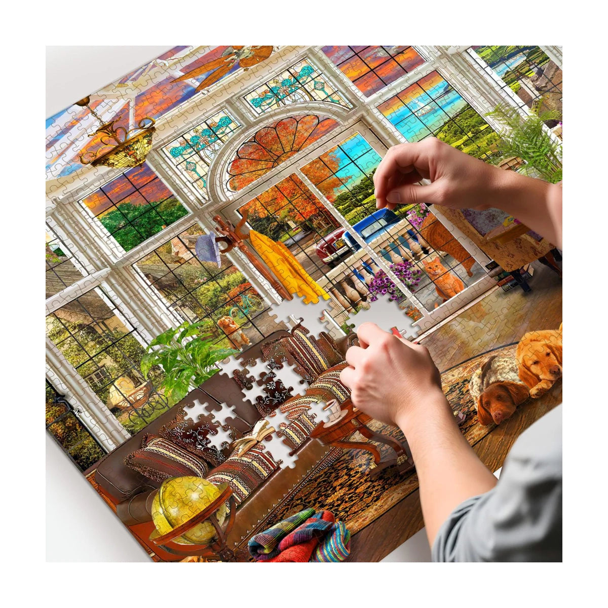 RGS Garden Room 1500pc puzzle in progress showing hand placing pieces in sunroom window scene