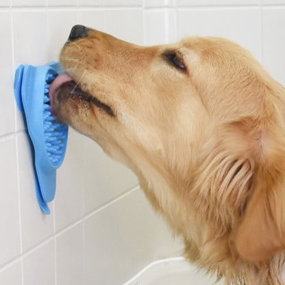 Dog licking treats from Rosewood Aquapaw Slow Treater suction lick mat during bath time