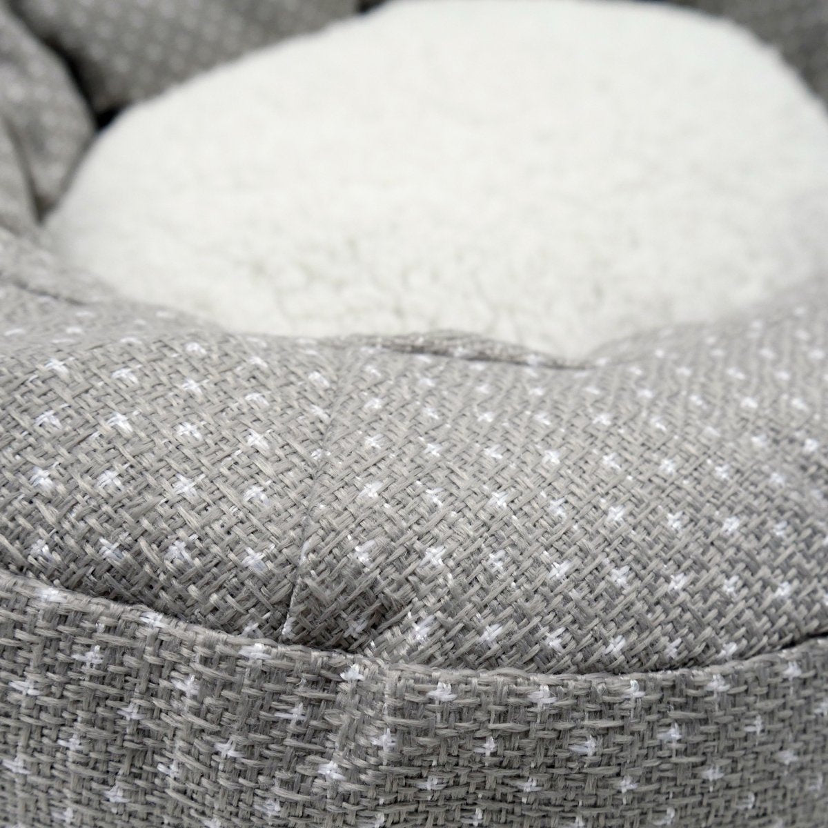 Close-up of the grey dotted fabric and white fleece centre of the Rosewood Dotty Feline Cat Bed