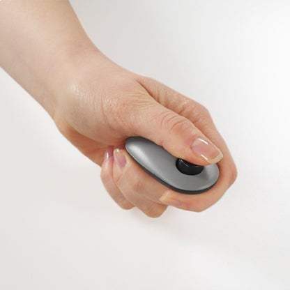 Rosewood Finger Clicker held in hand during dog training