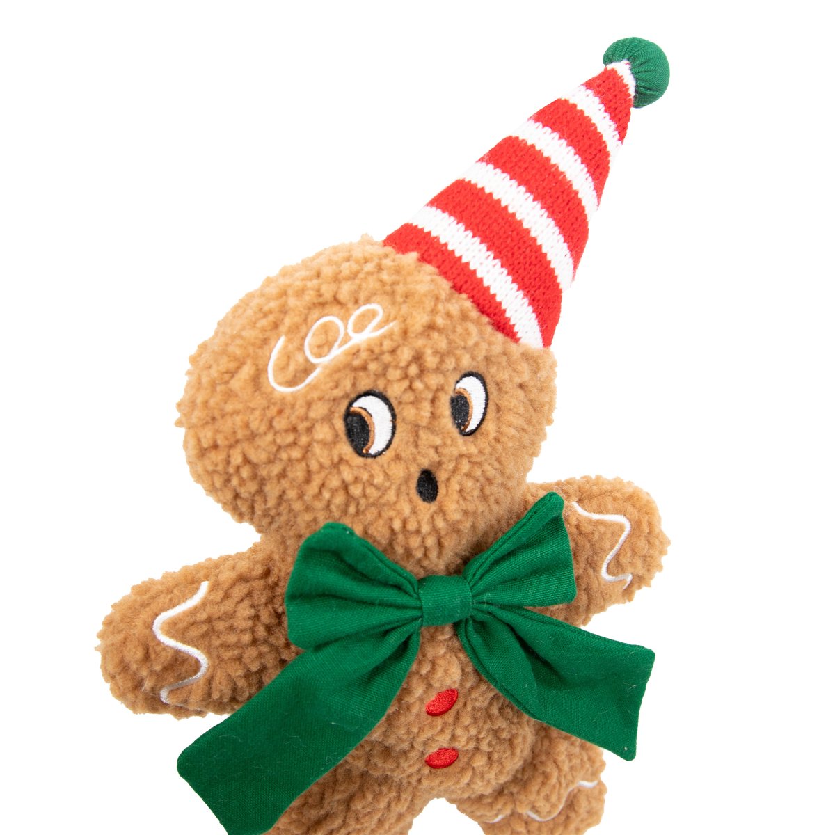 Close-up of Rosewood George Gingerbread Man plush dog toy showing textured brown bouclé, embroidered face, green bow, red buttons and striped Christmas hat.