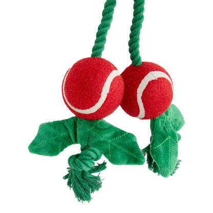 Close-up of two red balls with white curved detailing, green fabric leaves and knotted rope ends on Rosewood Holly Jolly Christmas dog toy.