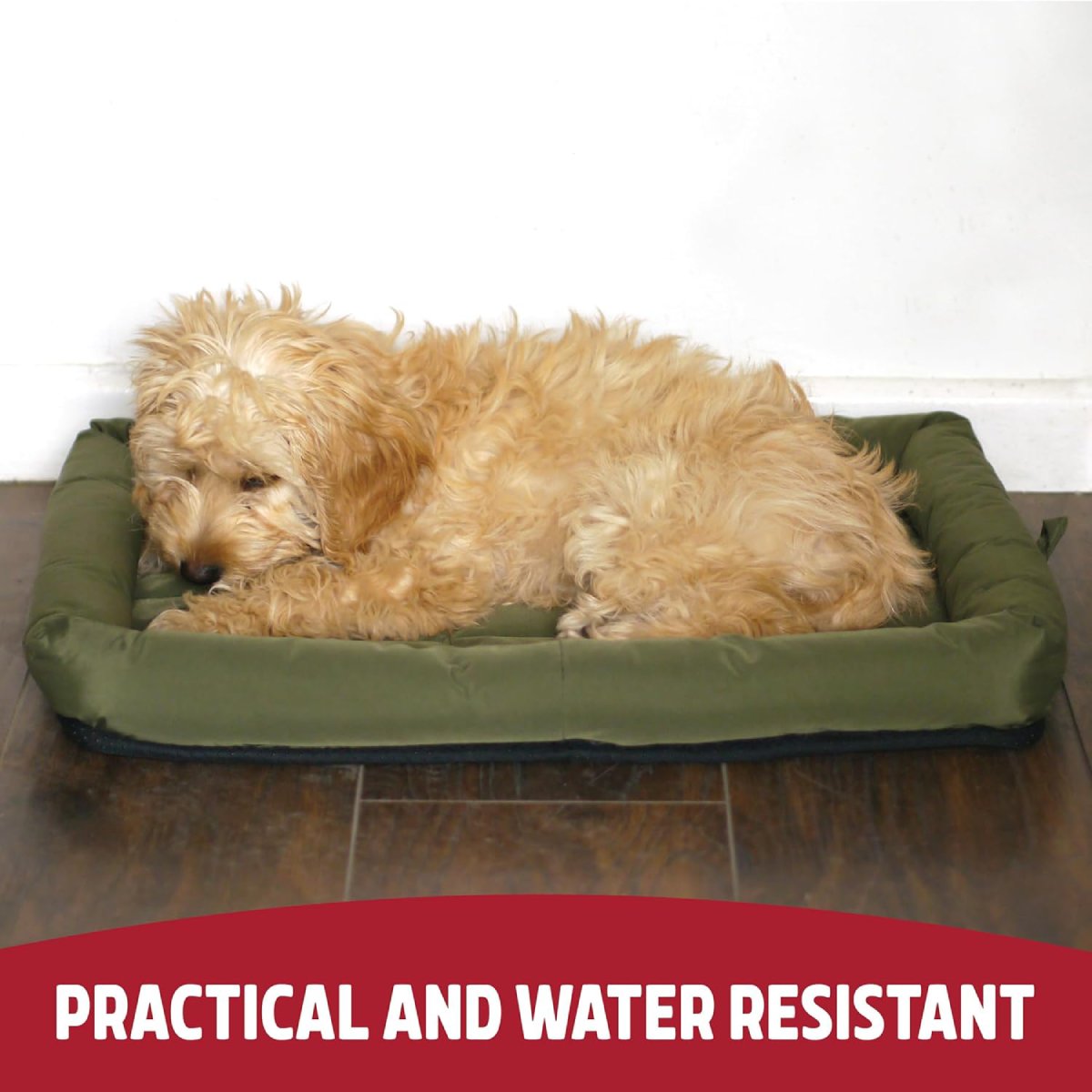 Small fluffy dog resting on a Rosewood Large green water-resistant crate mattress with quilted cushioning and raised padded sides on a wooden floor.