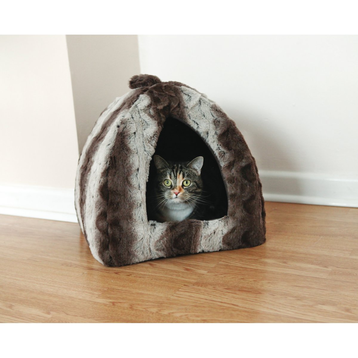 Cat sitting inside the Rosewood grey and cream Snuggle Plush Pyramid Cat Bed in a home setting