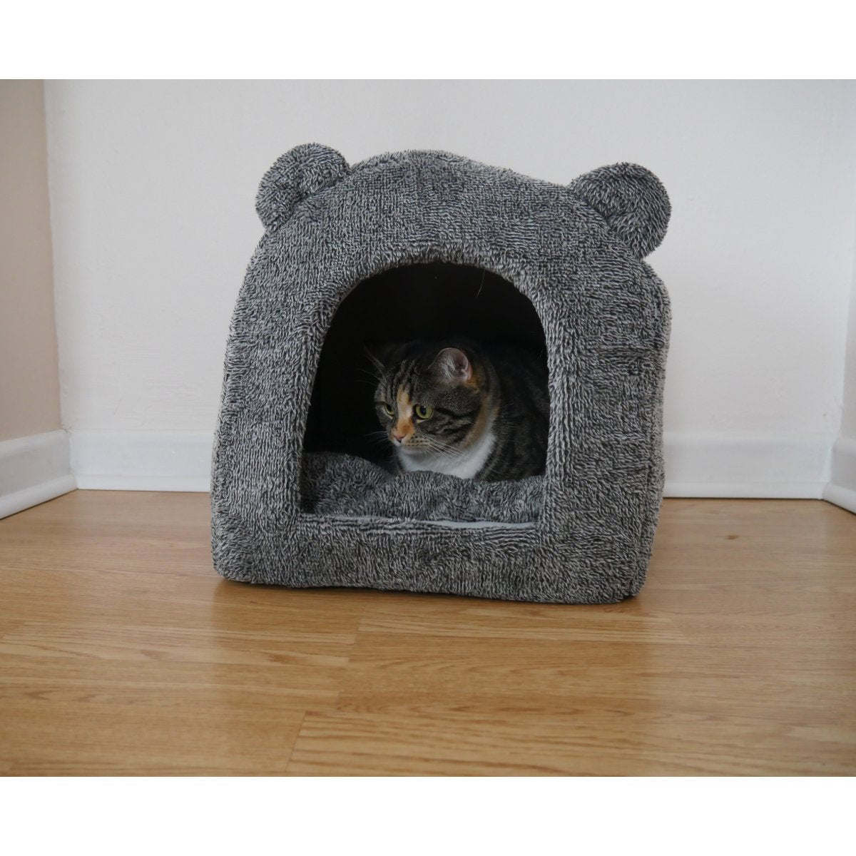 Cat resting inside the grey Rosewood Luxury Teddy Bear Cat Cave Bed in a home setting