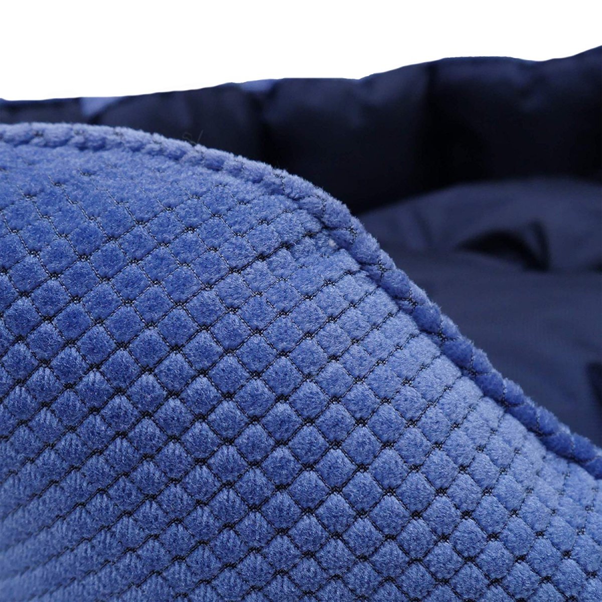 Close-up of the blue diamond-quilted outer canvas fabric and dark navy inner lining of the Rosewood Water-Resistant Dog Bed.