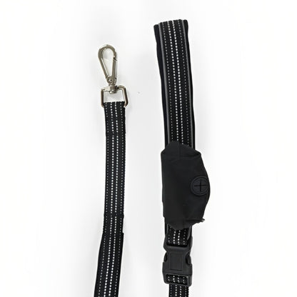 Close-up of the Rosewood Reflective Hands-Free Dog Lead showing its metal clasp, black reflective nylon webbing, waist belt buckle and attached pouch.